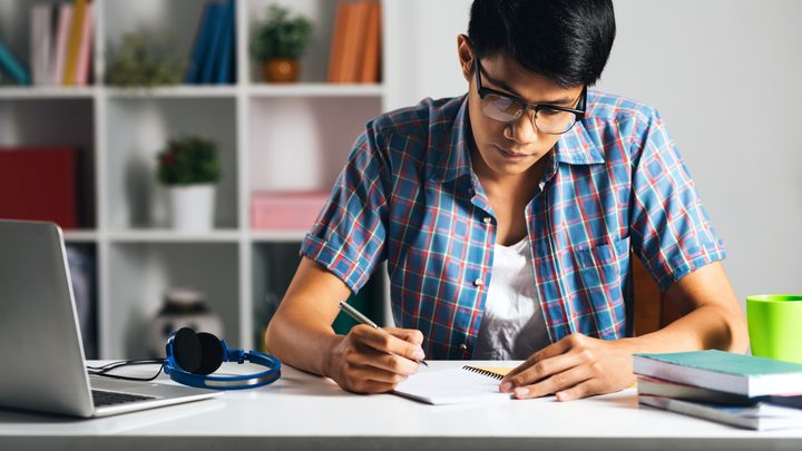 Student studying alone in his room