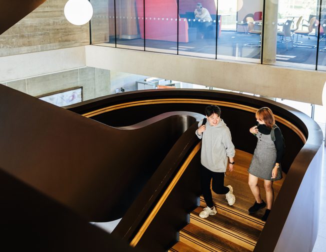 Students going down a stairways inside the university