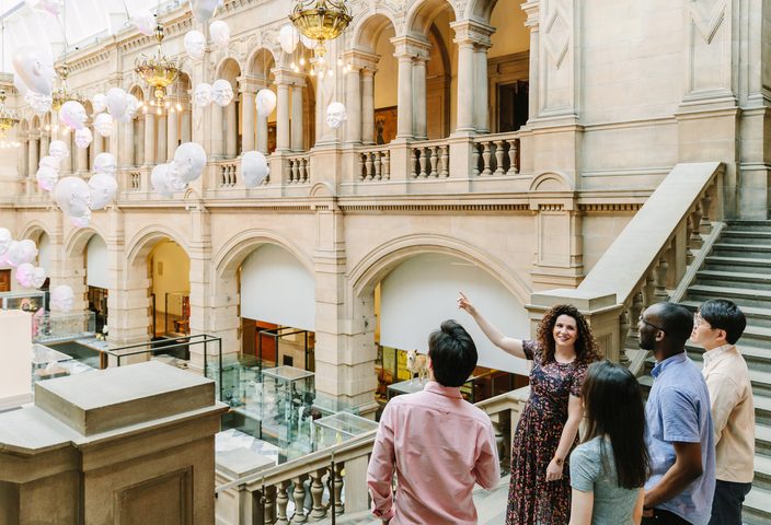 A group of student visiting the Kelvingrove Museum with their teacher