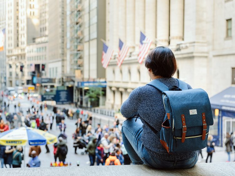 A student overlooking Wall Street in New York