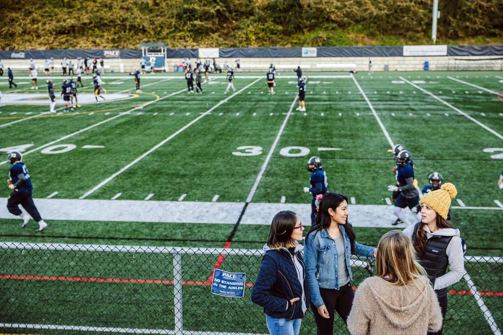 Some students hanging around a football field