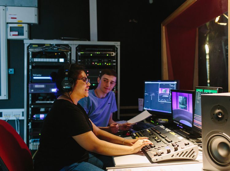 Students in a recording studio using the equipments