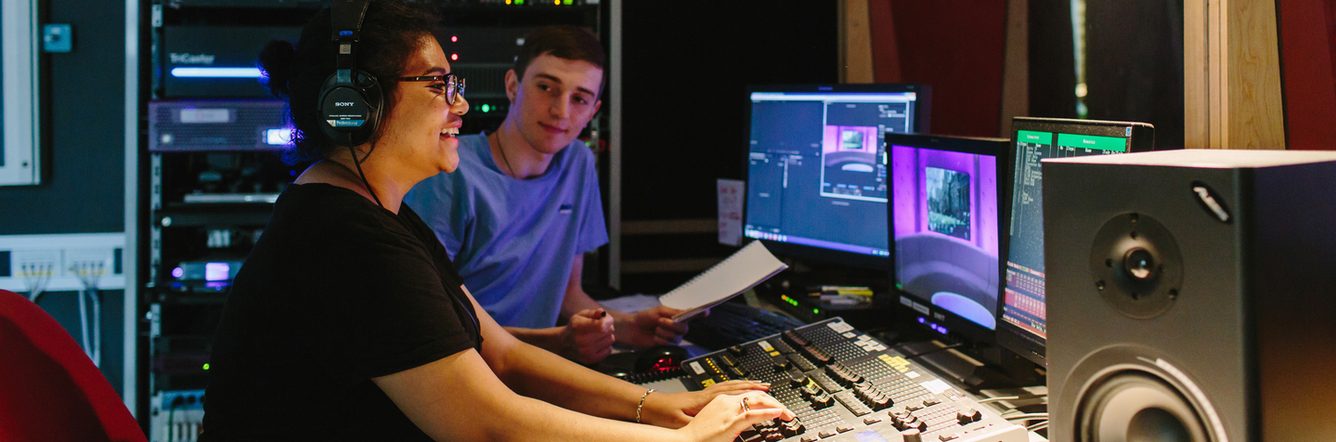 Students in a recording studio using the equipments