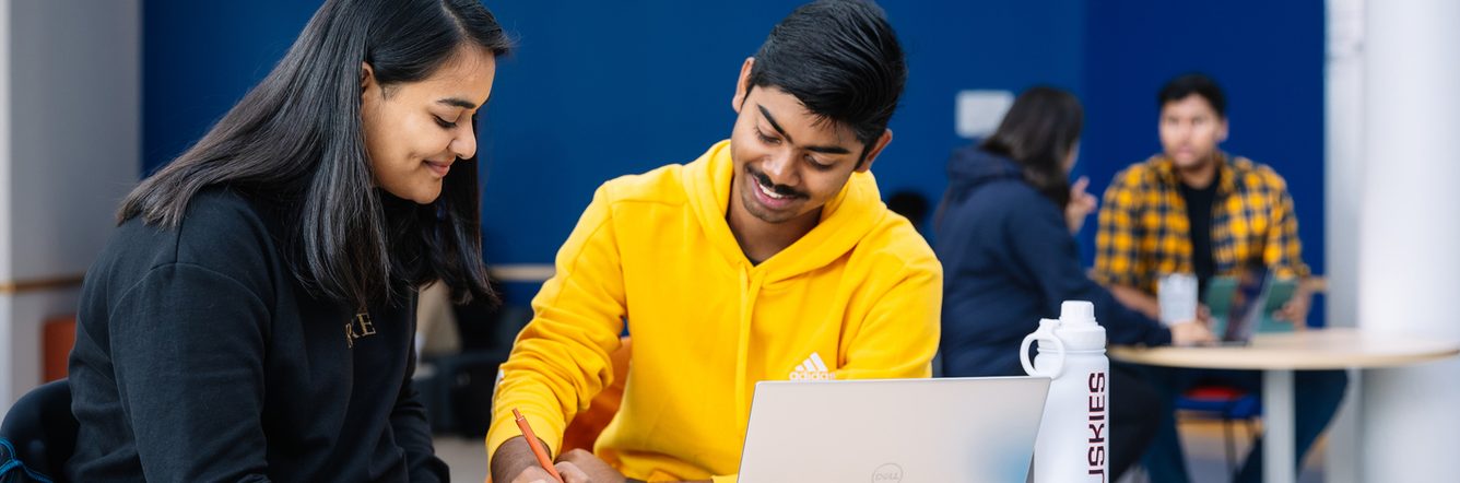 Two UCONN students studying together