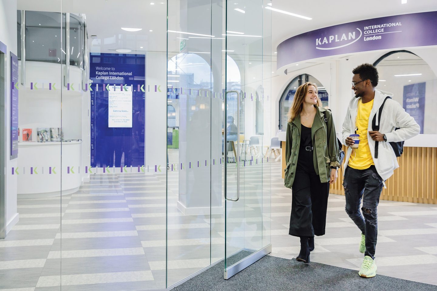 Two students exiting the college