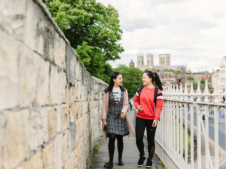 Students walking in york city with York Minster behind