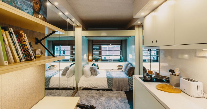 a studio room at the stay club kentish town in london with a kitchenette, study desk and a bed