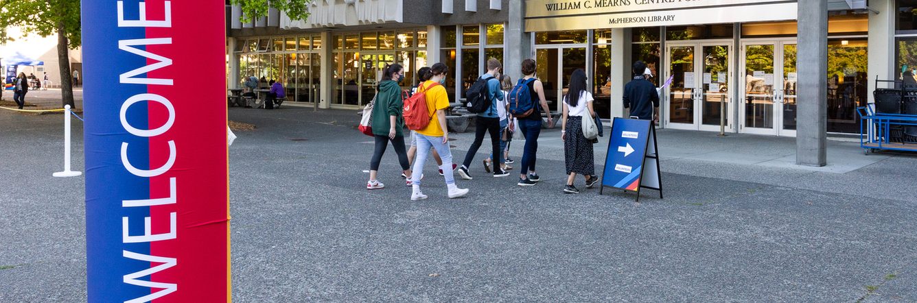 Students entering the library for the orientation