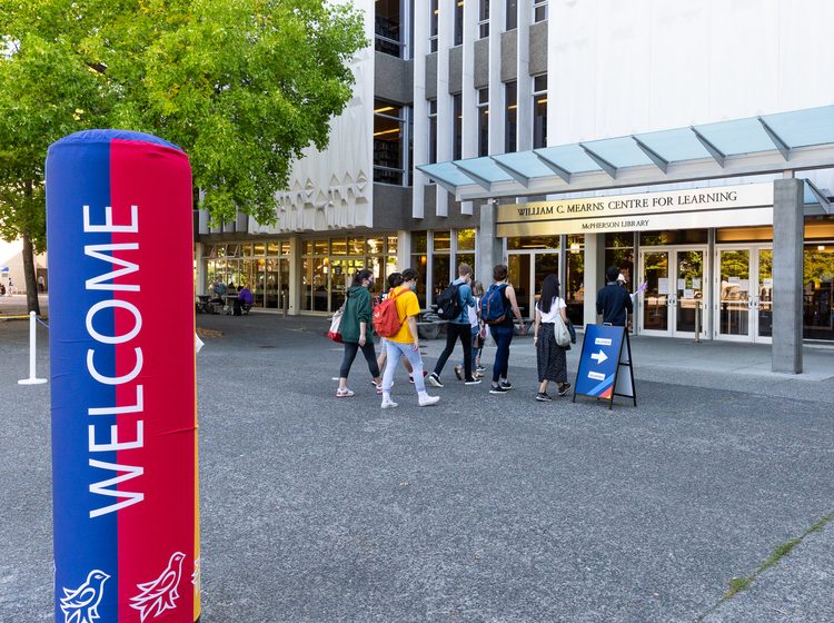 Students entering the library for the orientation