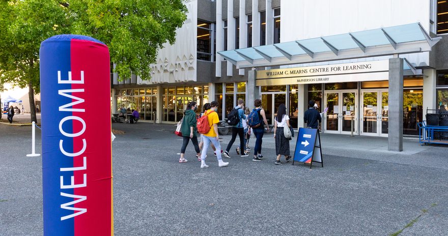 Students entering the library for the orientation