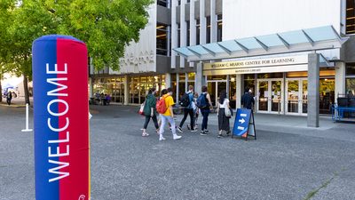 Students entering the library for the orientation