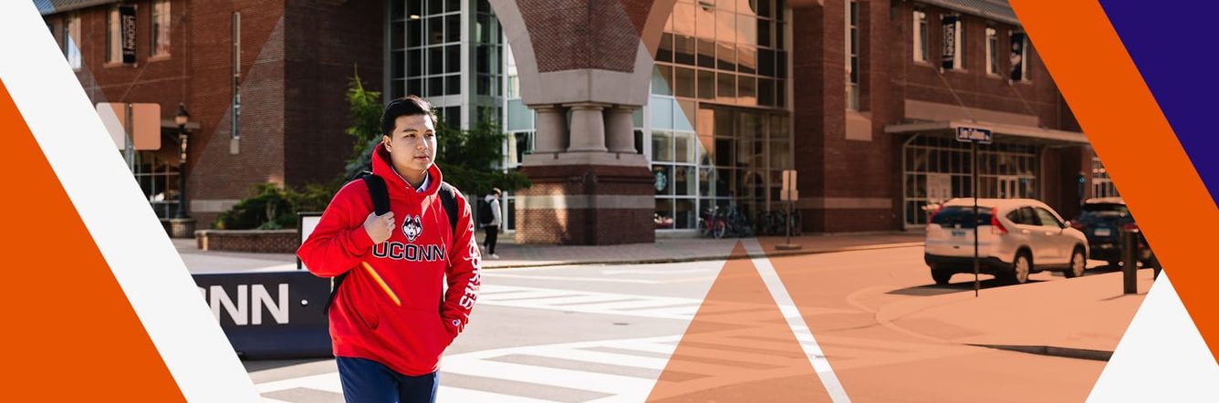 student walking outside uconn campus
