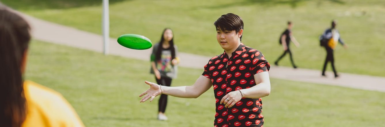 student flying disc in the park