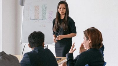 student in classroom with professor