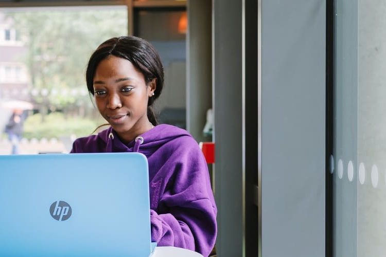 Student Ambassador Munashe sits at her laptop