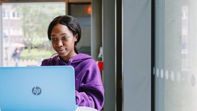 Student Ambassador Munashe sits at her laptop