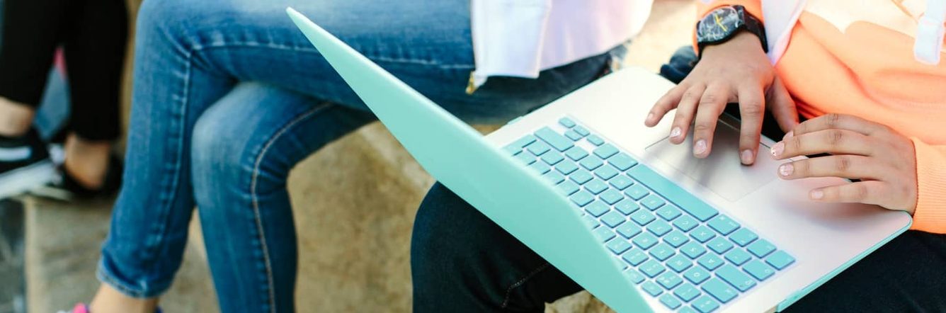 Close up of a laptop balanced on a student's lap