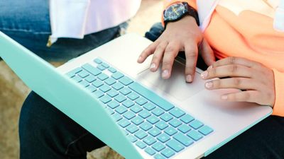 Close up of a laptop balanced on a student's lap