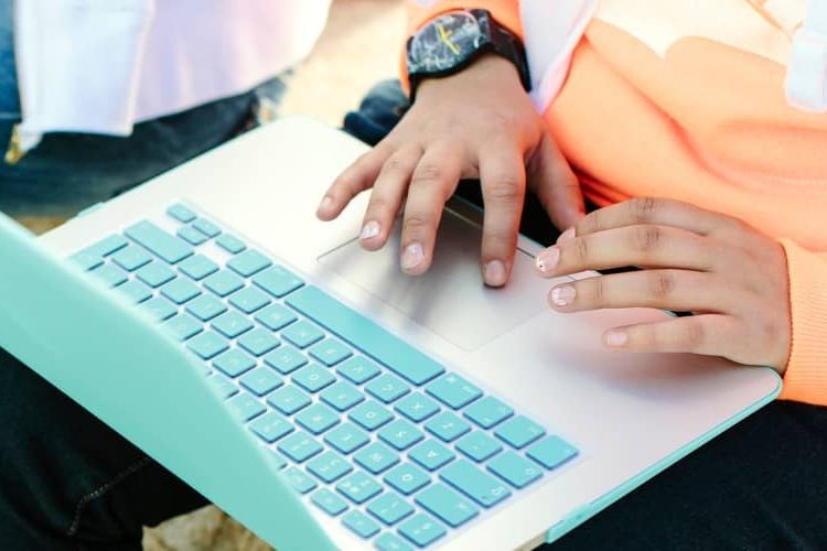 Close up of a laptop balanced on a student's lap