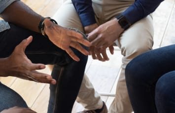 therapist counselling a group of people