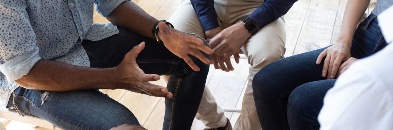 therapist counselling a group of people