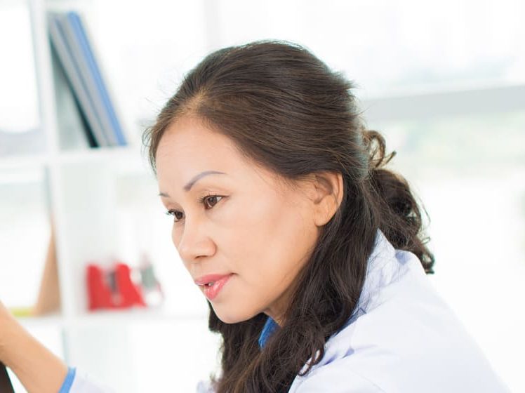 Female doctors examining x-ray