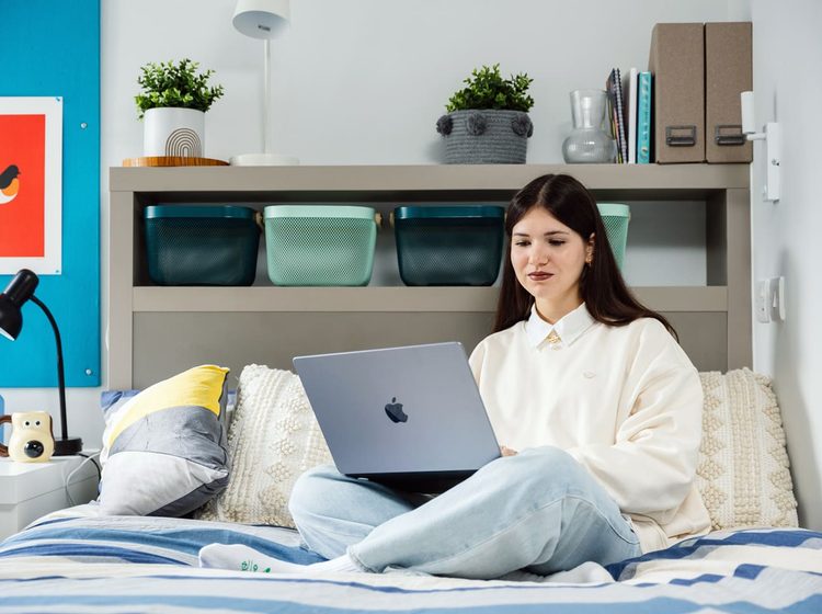 IFP student sitting in classic bedroom at university of bristol accommodation