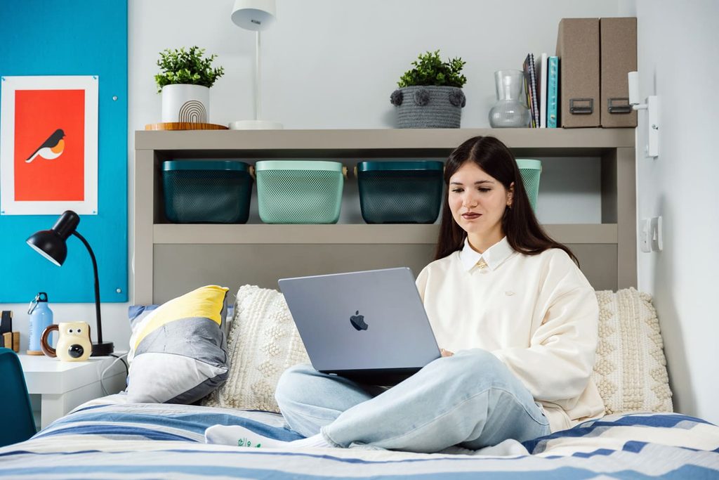 IFP student sitting in classic bedroom at university of bristol accommodation