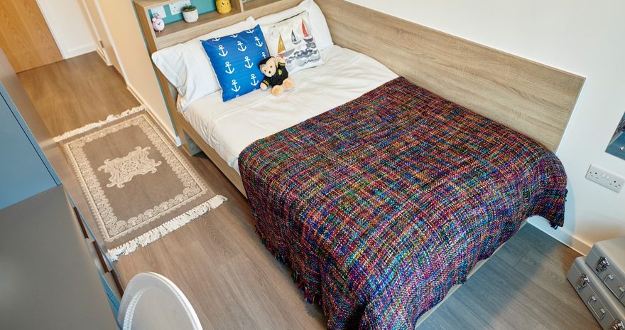 classic ensuite bedroom with a study desk, shelves and storage space