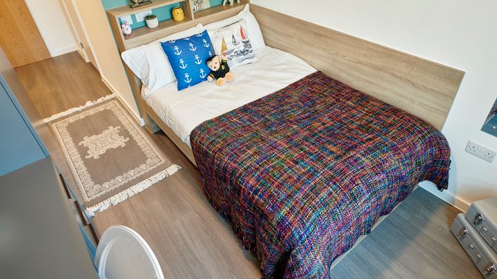 classic ensuite bedroom with a study desk, shelves and storage space