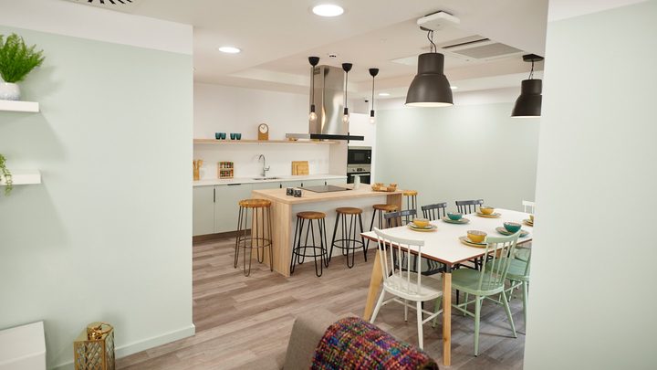 private dining room including kitchen and sofas