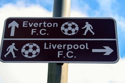 A sign explains the direction to Everton and Liverpool Football Club, England