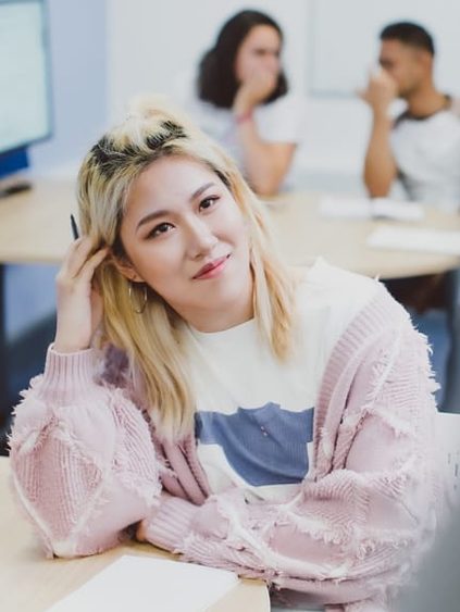 student holding pen in lecture