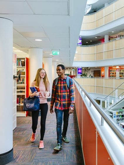 students walking in the library