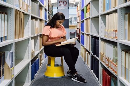 student reading book in library