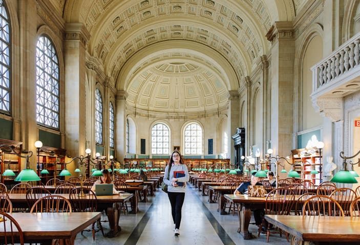 student walking in library