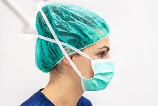 nurse with ear and hair mask on