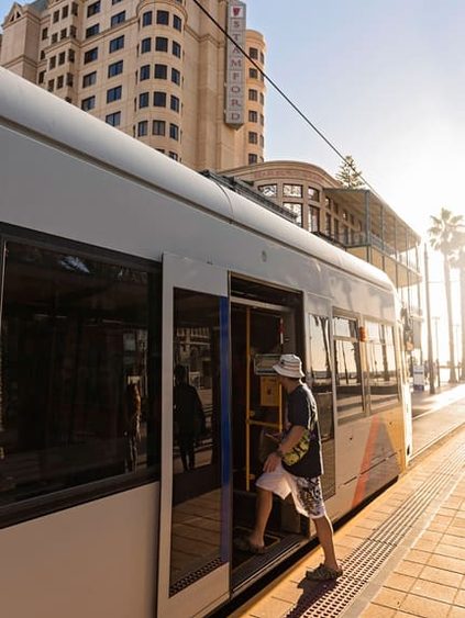 student boarding tram