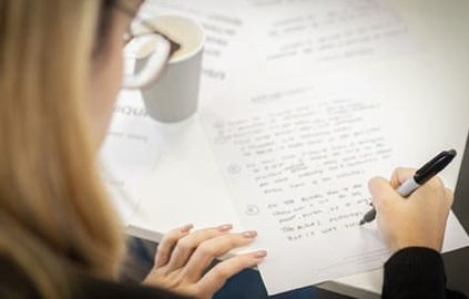 student writing on a paper