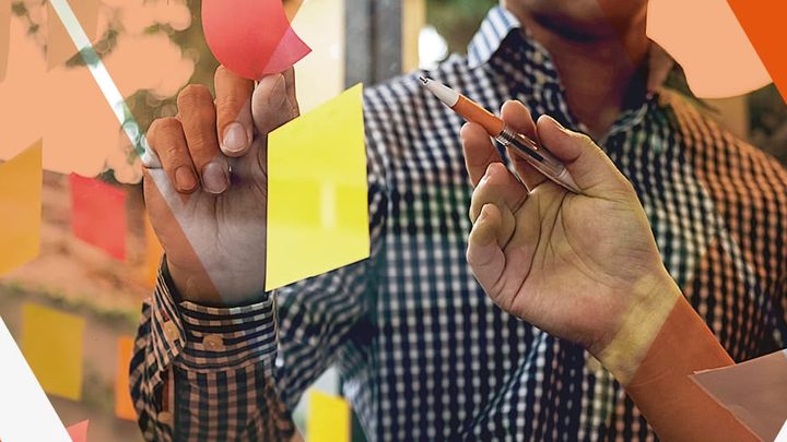 students pointing sticky notes