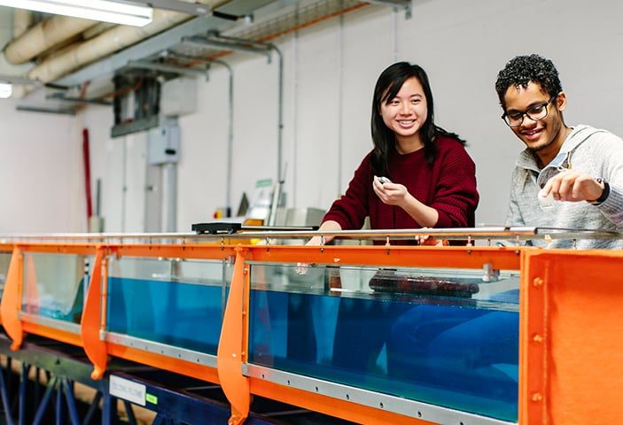 Students operating an engineering machine