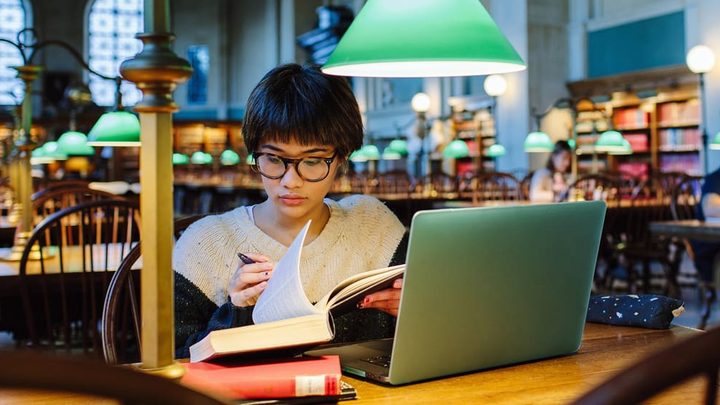 student studying in library