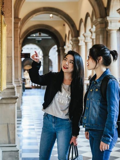 student pointing at an art piece in museum