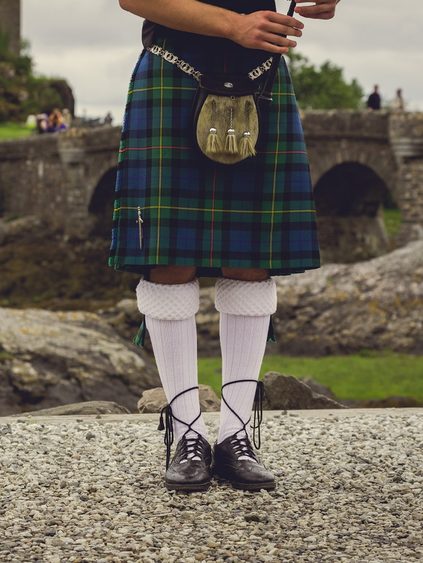 Close up legs of Bagpiper in traditional Scottish attire