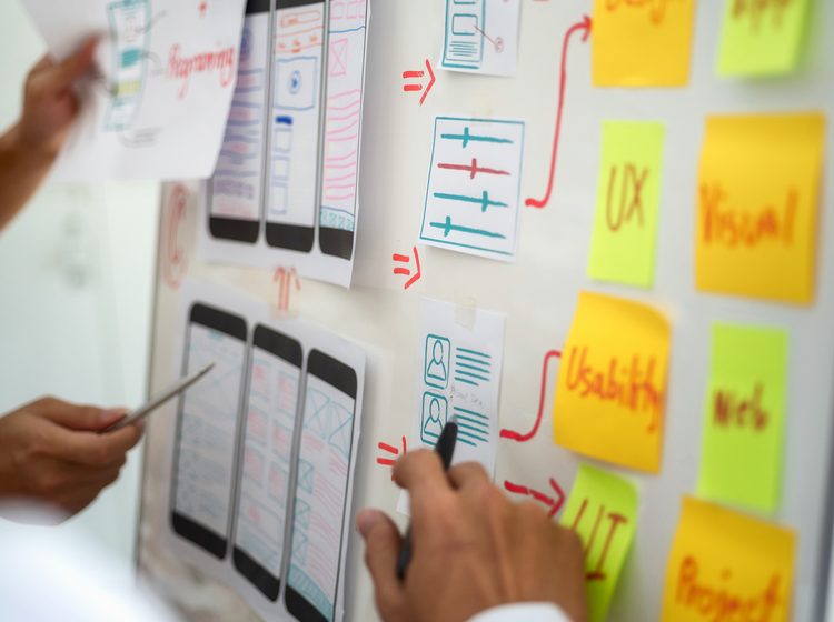 Close up of mobile app wireframe and sticky notes