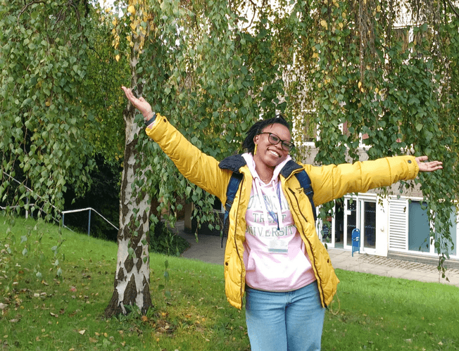 Esther Masanza from Nottingham posing in front of her accommodation