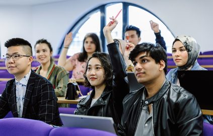 Group of students participating in their lecture politely with their hands up.