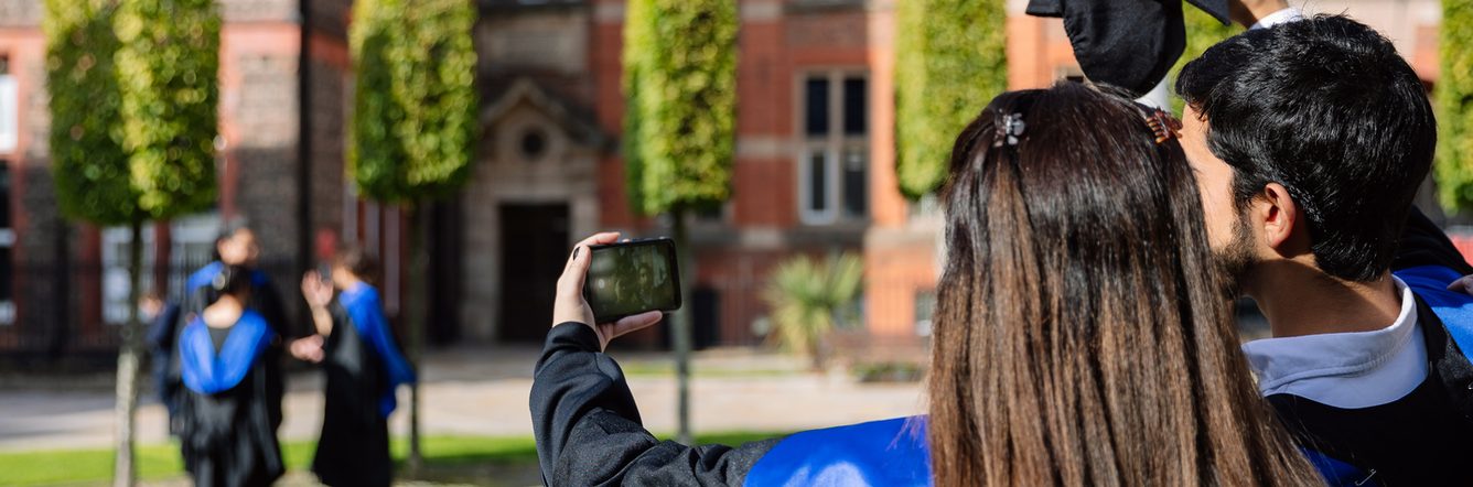 Two graduated students taking a selfie to celebrate their accomplishment