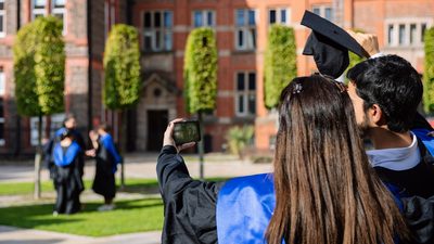 Two graduated students taking a selfie to celebrate their accomplishment