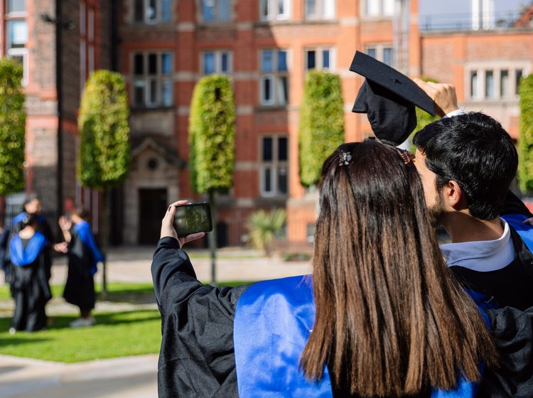 Two graduated students taking a selfie to celebrate their accomplishment